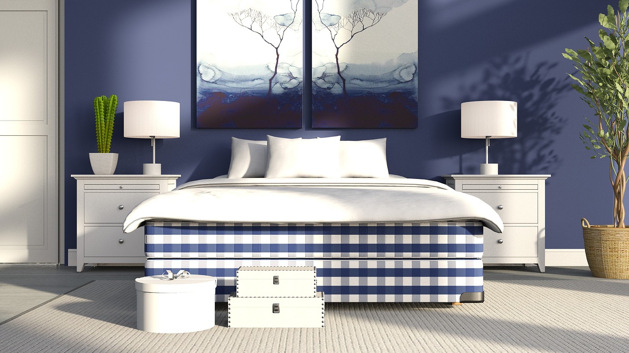 Biely koberec pod modrou manželskou posteľou